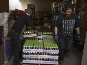 Iron Heart Canning employees stack recently canned beer at Other Half Brewing in Brooklyn.
