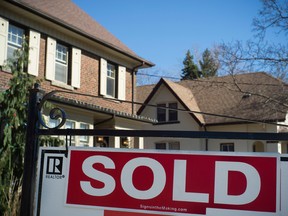 A sold sign is shown in front of west-end Toronto homes.