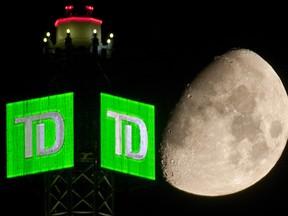 The Moon is seen beyond a Toronto-Dominion Bank (TD) logo displayed atop the TD Canada Trust Tower in the financial district of Toronto, Ontario, Canada, on Aug. 29, 2009.