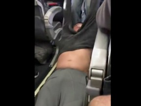 This Sunday, April 9, 2017, image made from a video provided by Audra D. Bridges shows a passenger being removed from a United Airlines flight in Chicago.