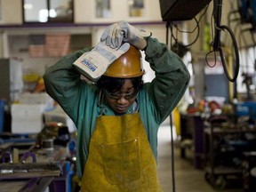 Journeywoman ironworker Bridget Booker dons her hard hat on a job in East Peoria, Ill.