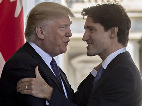 U.S. President Donald Trump, left, greets Justin Trudeau, Canada's prime minister, as he arrives to the West Wing of the White House in Washington, D.C., U.S., on Monday, Feb. 13, 2017.