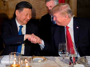 Chinese President Xi Jinping, left, and U.S. President Donald Trump  during dinner at the Mar-a-Lago estate in West Palm Beach, Fla.