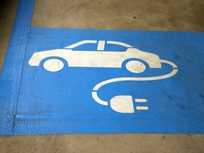 Signage for an electric car charging booth is displayed at Federation Square car park in Melbourne, Australia.