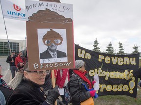 Protesters demonstrate in front of the Bombardier finishing plant as the company holds its annual meeting Thursday in Montreal.