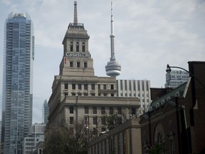 The Canada Life building (center) stands in front of the CN Tower (right), in the financial district of Toronto, on July 7, 2016.