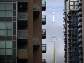 The CN Tower can be seen behind condos in Toronto's Liberty Village community in Toronto, Ontario on Tuesday, April 25, 2017.