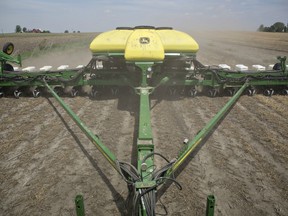 A planter distributes  corn seed on a field in Malden, Illinois, U.S.