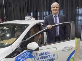 Federal Transport Minister Marc Garneau checks out the Chevrolet Volt at the Electric Vehicle Show in Montreal.