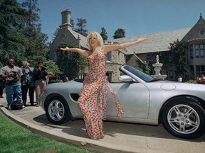 FIle photo of Victoria Silvstedt posing with her 1997 Porsche Boxter in front of the Playboy Mansion in Beverly Hills, Calif. The Playboy Mansion was also among the priciest homes to sell last year, bringing in $105 million.
