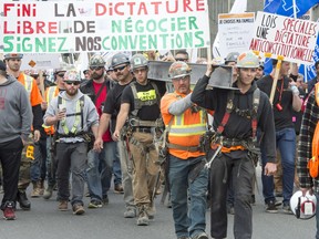 Quebec construction workers march during a demonstration as the province wide strike enters its second day Thursday, May 25, 2017 in Montreal.