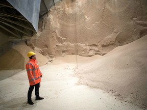 An employee looks at soybean meal produced by Glencore Plc as it is stored before transportation in a grain flat storage at the European Bulk Services (E.B.S.) terminal at the Port of Rotterdam in Rotterdam, Netherlands, on Tuesday, April 25, 2017. Since taking over Glencore Agriculture in 2002, Chris Mahoney has overseen the transformation of the unit into a standalone enterprise that generates more revenue from owning fixed assets in strategic locations than simply trading.