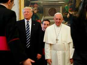 Pope Francis (R) stands with U.S. President Donald Trump during a private audience at the Vatican