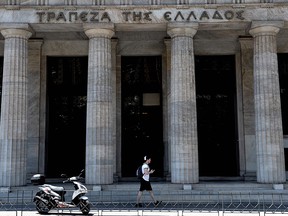 A man passes the Bank of Greece on May 30, 2017 in Thessaloniki.