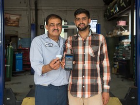 Paul Bhardwaj, left, and Shiva Bhardwaj with Shiva's Pitstop bluetooth device and smartphone app.
