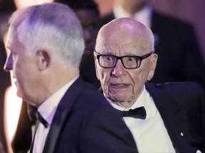 FILE - This is a Thursday, May 4, 2017 file photo of Rupert Murdoch, right, Chairman of Fox News Channel, as he walks with Australian Prime Minister Malcolm Turnbull, left, to their table for dinner aboard the USS Intrepid, a decommissioned aircraft carrier docked in the Hudson River in New York. Britain's Culture Secretary Karen Bradley is ruling on whether to permit the proposed 11.7 billion pound merge of Sky and Twenty-First Century Fox.  Bradley is set to offer her verdict Thursday June 29, 2017. The merger would allow Rupert Murdoch to consolidate his power base in British media. (AP Photo/Pablo Martinez Monsivais/File)