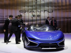 People check out the Qiantu K50 at the Shanghai auto show. Qiantu is part of a wave of fledgling automakers - all backed at least in part by Chinese investors - that are propelling the electric vehicle industry's latest trend: ultra-high-performance cars.