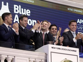 Blue Apron CEO Matt Salzberg, center, joins applause with co-founders Matt Wadiak, second left, and Ilia Papas, second from right, at the New York Stock Exchange before their IPO on June 29.