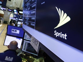 The Sprint logo appears above a trading post on the floor of the New York Stock Exchange, Tuesday, June 27, 2017. Sprint climbed 5.8 percent following a published report suggesting the mobile phone company is in talks with Charter Communications and Comcast Corp. on a deal that could enable the cable operators to buy a stake in Sprint. (AP Photo/Richard Drew)
