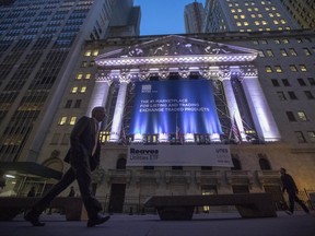 FILE - In this Tuesday, Oct. 25, 2016, file photo, a pedestrian walks past the New York Stock Exchange, in lower Manhattan. Technology and consumer-focused companies are leading stocks higher in early trading on Wall Street, Monday, June 26, 2017. (AP Photo/Mary Altaffer, File)