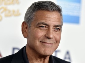 FILE - In this Saturday, Oct. 1, 2016, file photo, George Clooney arrives at MPTF's 95th Anniversary Celebration "Hollywood's Night Under The Stars" in Los Angeles. Global liquor behemoth Diageo says it will pay up to $1 billion to buy a tequila brand co-founded by movie star George Clooney. Clooney founded the Casamigos brand with partners Rande Gerber and Mike Meldma. Diageo says it will pay $700 million for Casamigos at first, and then pay another $300 million over 10 years if the brand reaches certain performance milestones. (Photo by Jordan Strauss/Invision/AP, File)