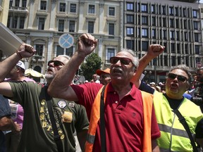 Protesters chant slogans during a rally outside the Interior Ministry in Athens, on Monday, June 26, 2017. With a heat wave expected later this week, Greece's government Monday urging striking garbage collectors to return to work after a 10-day protest has left huge piles of trash around Athens. (AP Photo/Yorgos Karahalis)