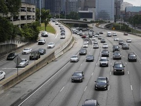 In this Thursday, May 19, 2016, photo, traffic flows out of downtown Atlanta on the Interstate 75/85 Connector, in Atlanta. More people are expected to put down the TV remote and hit the road for the July 4, 2017, weekend. Auto club AAA predicts that 44.2 million people will travel over the holiday period, most of them by car, up 2.9 percent over a year earlier. (AP Photo/John Bazemore)