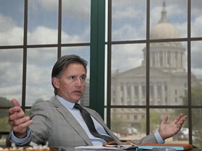 FILE - In this May 4, 2017 file photo, Oklahoma Attorney General Mike Hunter speaks during an interview in his office in Oklahoma City. Hunter, and Oklahoma's insurance commissioner have sent separate letters signed by several state attorneys general, insurance commissioners and one governor asking California's insurance commissioner to stop asking insurance companies to publicly disclose their investments in fossil fuels and to divest from the coal industry. (AP Photo/Sue Ogrocki File)