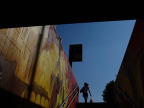 A woman walks down the staircases of a subway stop, in Milan, Italy, Tuesday, June 20, 2017. (AP Photo/Luca Bruno)