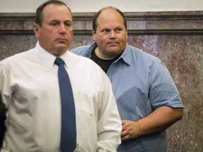 Eddie Tipton, the cyber security expert and brainpower behind a lottery rigging scandal that netted $2 million in illegal winnings from five state lotteries pleaded guilty Thursday, June 29, 2017, to a felony charge of ongoing criminal conduct charge at the Polk County Courthouse in Des Moines, Iowa. Tommy Tipton, Eddie's brother, is at left. Eddie Tipton on Thursday admitted for the first time that he manipulated the computer software he helped design, allowing him to pick winning numbers. Tipton and his brother, Tommy Tipton will repay $3 million in prizes they improperly claimed as part of a plea agreement they've reached with prosecutors in Iowa and Wisconsin.  (Rodney White/The Des Moines Register via AP)