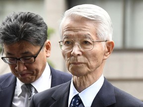 Tsunehisa Katsumata, right, former chairman of Tokyo Electric Power Co. (TEPCO), arrives at Tokyo District Court for a trial in Tokyo Friday, June 30, 2017. Three former executives of TEPCO, including Katsumata, are going on trial for alleged negligence in the 2011 Fukushima nuclear disaster. The trial is the first to consider whether the utility can be held criminally responsible. (Shigeyuki Inakuma/Kyodo News via AP)