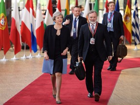 British Prime Minister Theresa May and the EU Ambassador for the U.K. Tim Barrow arrive at the EU Council headquarters in Brussels, Belgium.