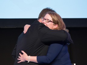 Melissa Kennedy of Sun Life gets a hug from Simon Fish of BMO Financial Group. Kennedy received Environmental, Social and Governance award at the 2017 CGCAs