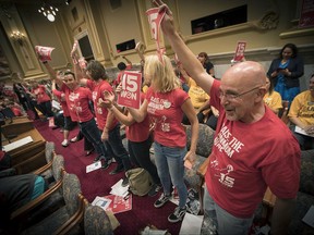 Supporters of the $15 minimum wage increase celebrated after it was passed by the City Council at City Hall, Friday, June 30, 2017 in Minneapolis. Minneapolis became the latest city to approve a big hike in its minimum wage, with the City Council voting to hike it to $15 by 2022 (Elizabeth Flores/Star Tribune via AP)