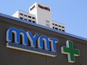 FILE- This June 21, 2017, file photo shows a sign on the Mynt Cannabis Dispensary across the street from Harrah's hotel-casino in downtown Reno, Nev. The Mynt is one of at least four medical marijuana dispensaries in Reno that have received the necessary local licenses and are ready to start selling marijuana for recreational use on July 1 as long as they get their anticipated state license. (AP Photo/Scott Sonner, File)