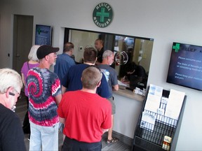FILE - In this July 31, 2015, file photo, people line up to be among the first in Nevada to legally purchase medical marijuana at the Silver State Relief dispensary in Sparks, Nev. Nevada's marijuana regulators are working furiously to launch recreational sales on July 1, a fast-approaching deadline that could hinge on a court deciding whether the powerful liquor industry should be guaranteed a piece of the pot pie before tourists and residents can light up. Lawyers for the liquor industry, marijuana retailers and the state are facing a judge Monday, June 19, 2017, to argue whether Nevada has the authority to issue marijuana distribution licenses to anyone besides alcohol distributors. (AP Photo/Scott Sonner, File)