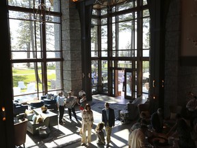 In this June 20, 2017 photo provided by Douglas County, people gather in the grand hall of the Edgewood Tahoe Lodge for its grand opening on the south shore of Lake Tahoe in Stateline, Nev. The $100 million lodge has 154 rooms and was built in conjunction with an ambitious project to protect wetlands and filter stormwater runoff harmful to the lake's clarity. (Melissa Blosser/Douglas County Public Information Officer via AP)