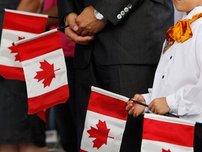 New Canadians receive their citizenship at a ceremony in Toronto.