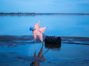 A scarecrow set up in a tailings pond, a dam and dyke system used in oil sands processing, north of Fort McMurray, Alberta
