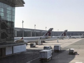 In this Friday, June 16, 2017 photo, Qatar Airways planes are seen parked at the Hamad International Airport in Doha, Qatar. The deadline for Qataris to leave neighboring Gulf Arab states has come into effect as the diplomatic standoff persists despite multiple mediation efforts. (AP Photo/Malak Harb)