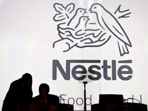 FILE - In this April 7, 2016 file picture Nestle's directors speak in front of the Nestle's logo during the general meeting of Nestle Group, in Lausanne, Switzerland. Nestle says Monday, June 26, 2017  it's keeping "an open dialogue with all of our shareholders" after news reports that a U.S. hedge fund has taken a large stake sent shares of the Swiss food and beverages giant soaring.  (Laurent Gillieron/Keystone via AP,file)