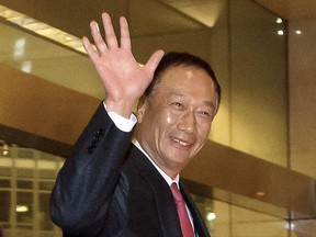 FILE - In this Sunday, Feb. 24, 2013, file photo, Foxconn Technology Group Chairman Terry Gou waves as he arrives at a hotel in Beijing. Gou says there is 'still a chance' the Taiwanese electronics giant might be able to buy Toshiba's chip business despite the Japanese company's choice of another bidder as its preferred buyer. (AP Photo/Andy Wong, File)