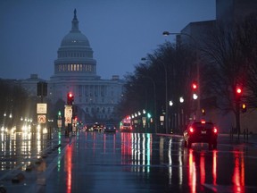 FILE - In this March 31, 2017, file photo, The U.S. Capitol is seen in the distance as rain falls on Pennsylvania Avenue in Washington. Why are Republicans struggling mightily to reach a consensus on how to overhaul the nation's tax system? The GOP is supposed to be really good at cutting taxes. (AP Photo/J. Scott Applewhite, file)