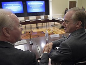 Health and Human Services Secretary Tom Price, left, shakes hands with Veterans Affairs Secretary David Shulkin before the start of a meeting of the President's Commission on Combating Drug Addiction and the Opioid Crisis, Friday, June 16, 2017, in the Eisenhower Executive Office Building at the White House complex in Washington. (AP Photo/Susan Walsh)