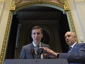 White House senior adviser Jared Kushner, left, with the assistance of Assistant to the President Chris Liddell, right, tries to quiet the audience so he can speak at the opening session of the White House meeting with technology Chief Executive Officers to mark "technology week," Monday, June 19, 2017, in the Indian Treat Room of the Eisenhower Executive Office Building on the White House complex in Washington. The White House Office of American Innovation is hosting a series of working sessions to generate ideas to transform and modernize Government Services. (AP Photo/Susan Walsh)