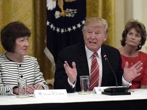 President Donald Trump, center, speaks as he meets with Republican senators on health care in the East Room of the White House in Washington, Tuesday, June 27, 2017. Sen. Susan Collins, R-Maine, left, and Sen. Lisa Murkowski, R-Alaska, right, listen (AP Photo/Susan Walsh)