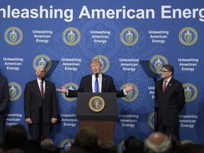 President Donald Trump, center, standing with from left, Interior Secretary Ryan Zinke, Vice President Mike Pence, Energy Secretary Rick Perry and Environmental Protection Agency Administrator Scott Pruitt, speaks at the Department of Energy in Washington, Thursday, June 29, 2017. (AP Photo/Susan Walsh)