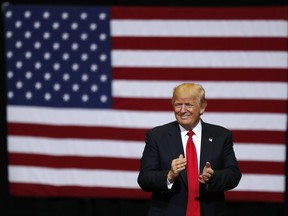 President Donald Trump smiles at supporters as he arrives to speak at a rally, Wednesday, June 21, 2017, in Cedar Rapids, Iowa. (AP Photo/Charlie Neibergall)