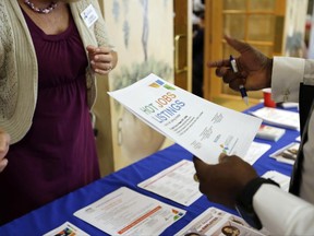 FILE - In this Tuesday, Oct. 6, 2015, file photo, employment opportunities are discussed at a job fair for veterans, in Pembroke Pines, Fla. On Thursday, June 22, 2017, the Labor Department reports on the number of people who applied for unemployment benefits a week earlier. (AP Photo/Lynne Sladky, File)