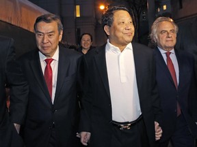 FILE - In this Monday, Oct. 26, 2015, file photo, Chinese billionaire Ng Lap Seng, center, leaves federal court with his attorney Benjamin Brafman, right, after he was released on bail in connection with a United Nations bribery scheme in New York. Jury selection began Monday, June 26, 2017, in the New York criminal trial of Ng. (AP Photo/Kathy Willens, File)